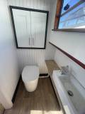 Shower room with composting toilet and basin